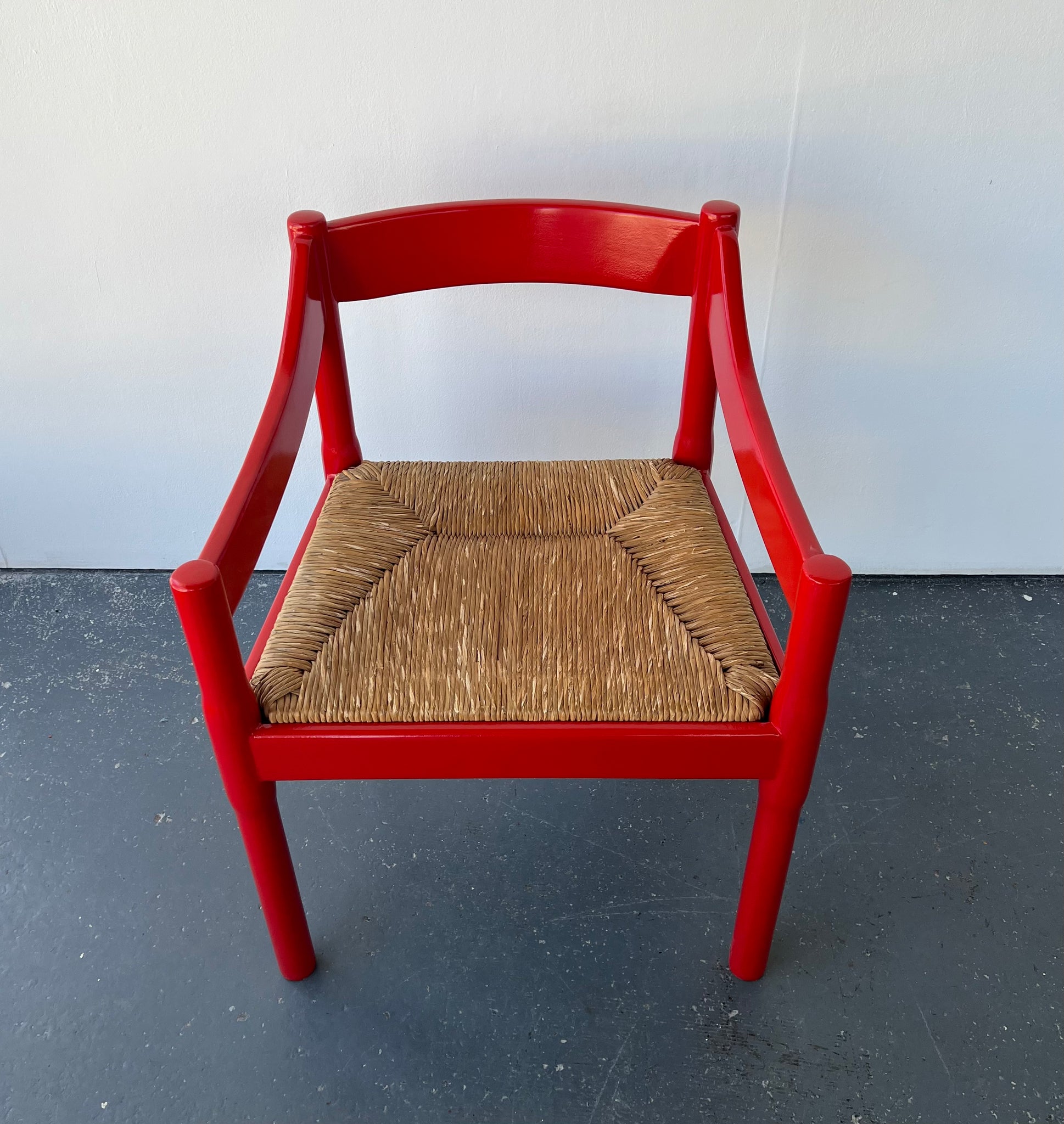 Single Red Glossy Carimate Carver Chairs by Vico Magistretti
